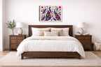 Peacocks - Abstract Geometric Painting printed on canvas wall art displayed on a wall above a bed.