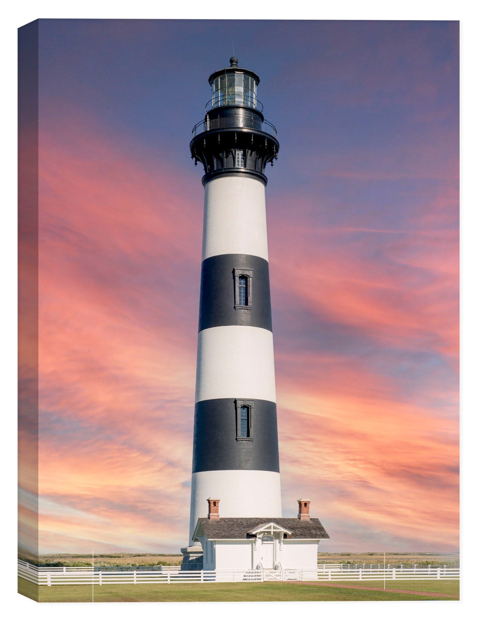 Lighthouse with black and white stripes against a colorful sky
