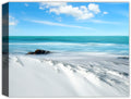 Image of a windswept beach with clear blue ocean and puffy clouds - printed on canvas