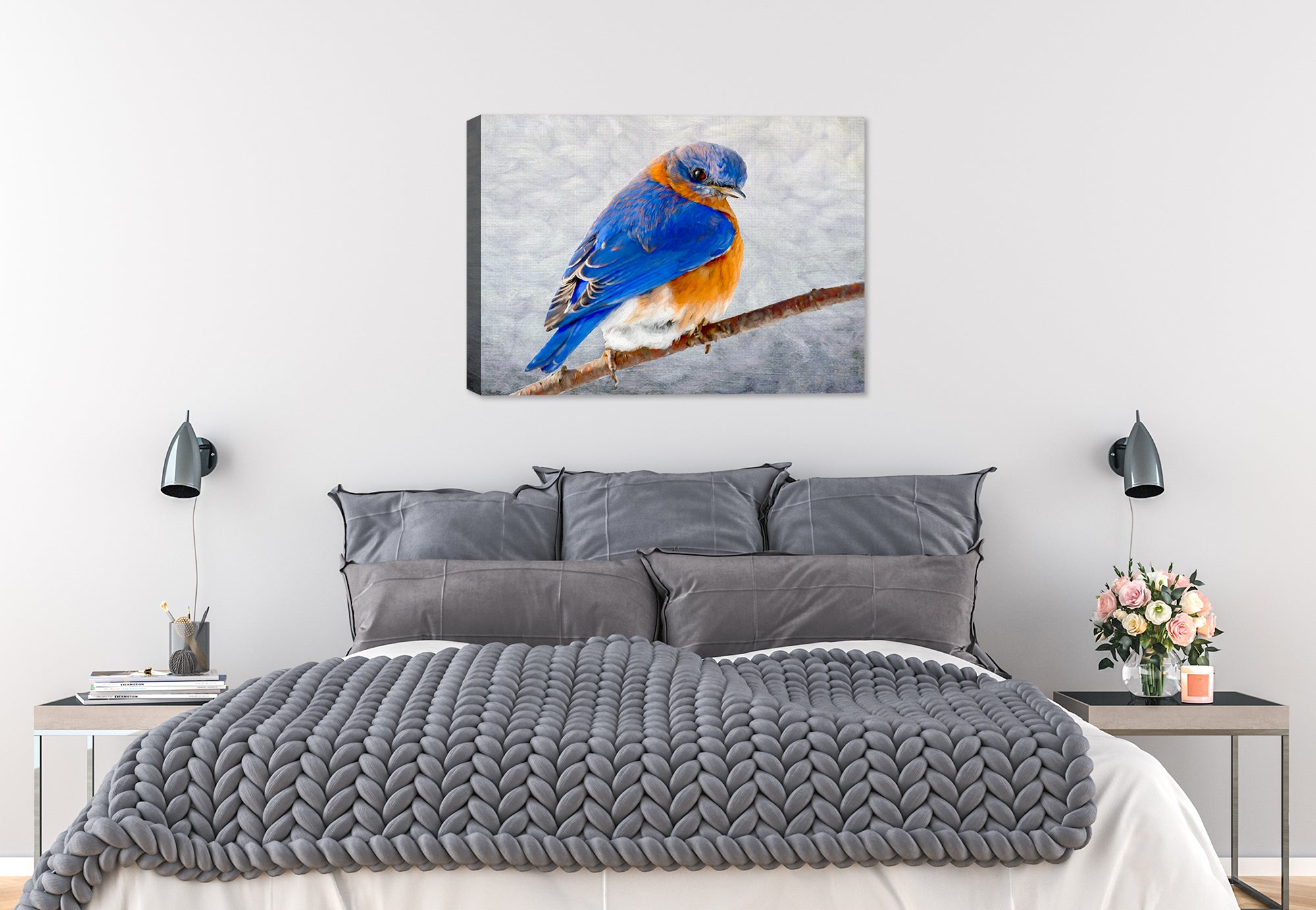 Painting of a bluebird on a branch by Carol Decker, printed on a canvas wrap hanging on a wall in the bedroom.