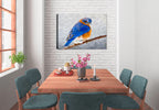 Painting of a bluebird on a branch by Carol Decker, printed on a canvas wrap hanging on a wall in the dining room.