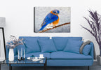 Painting of a bluebird on a branch by Carol Decker, printed on a canvas wrap hanging on a wall in the living room.
