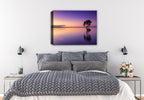 Image of a lone tree in the middle of a purplish colored water and sky.  Printed on Canvas. Hung on a Bedroom Wall. 