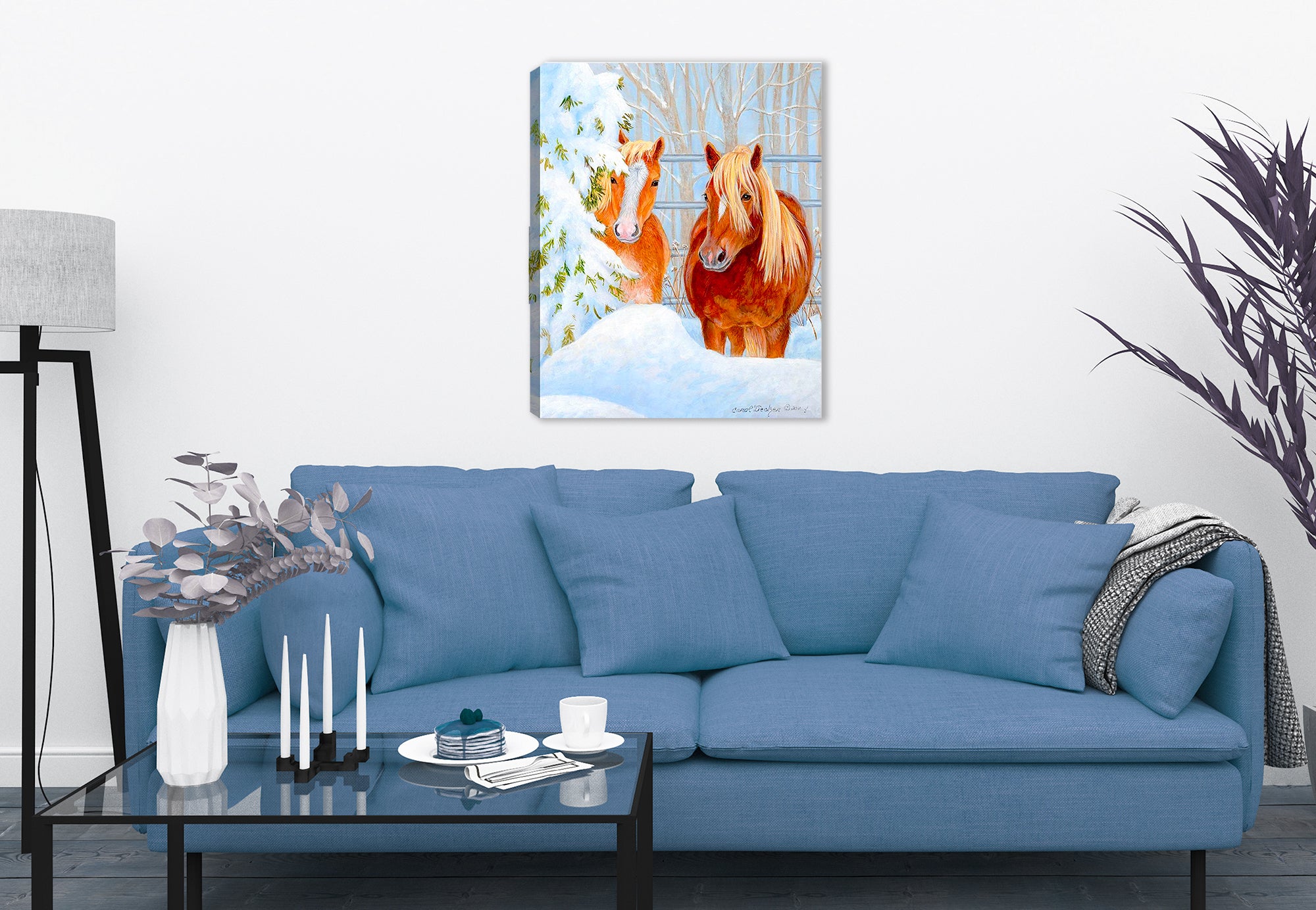 Painting of horses in the snow printed on a canvas wrap hanging on the wall of a living room. 
