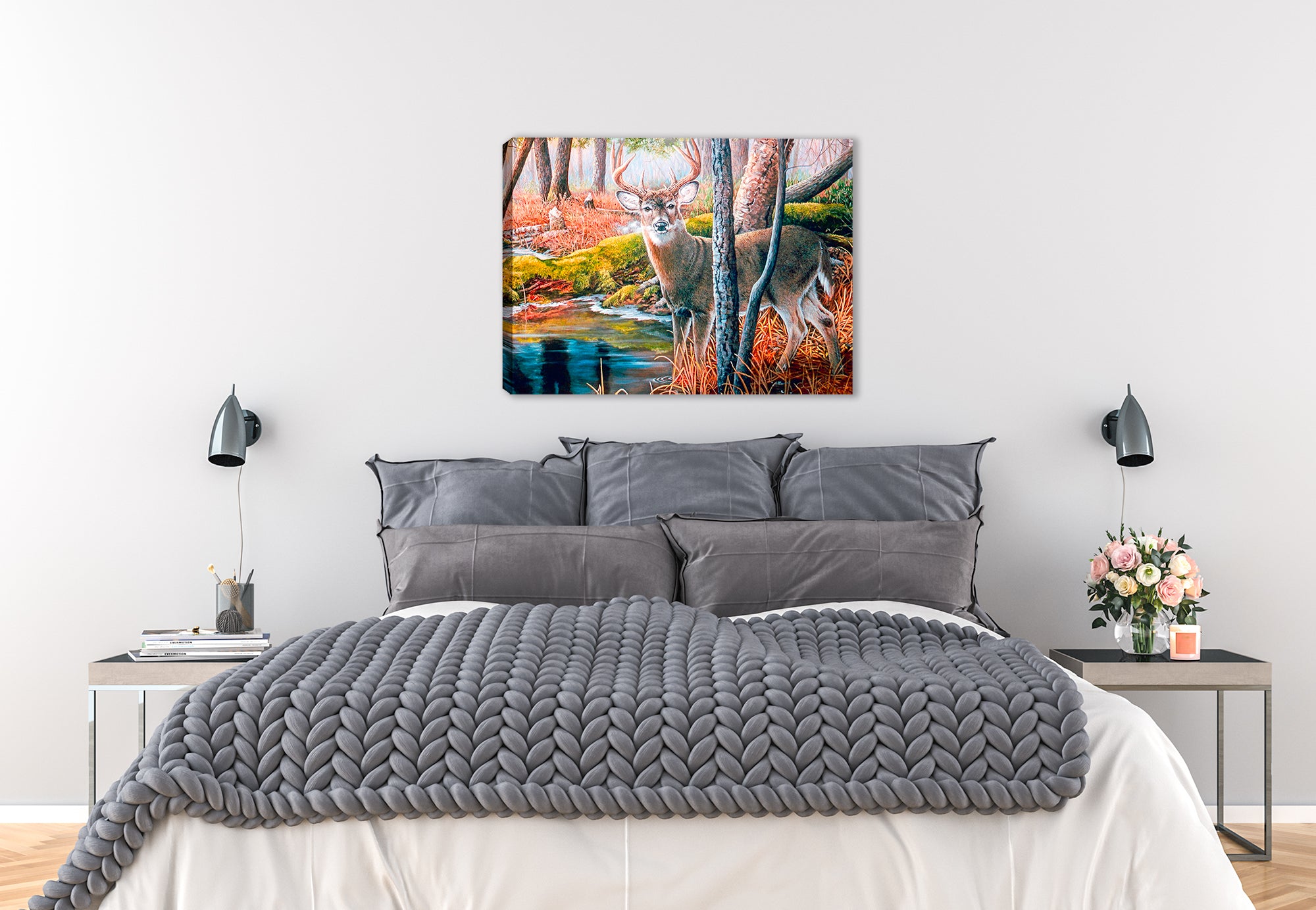 Canvas wrap image of a buck by the water in the woods hanging on the wall of a bedroom.